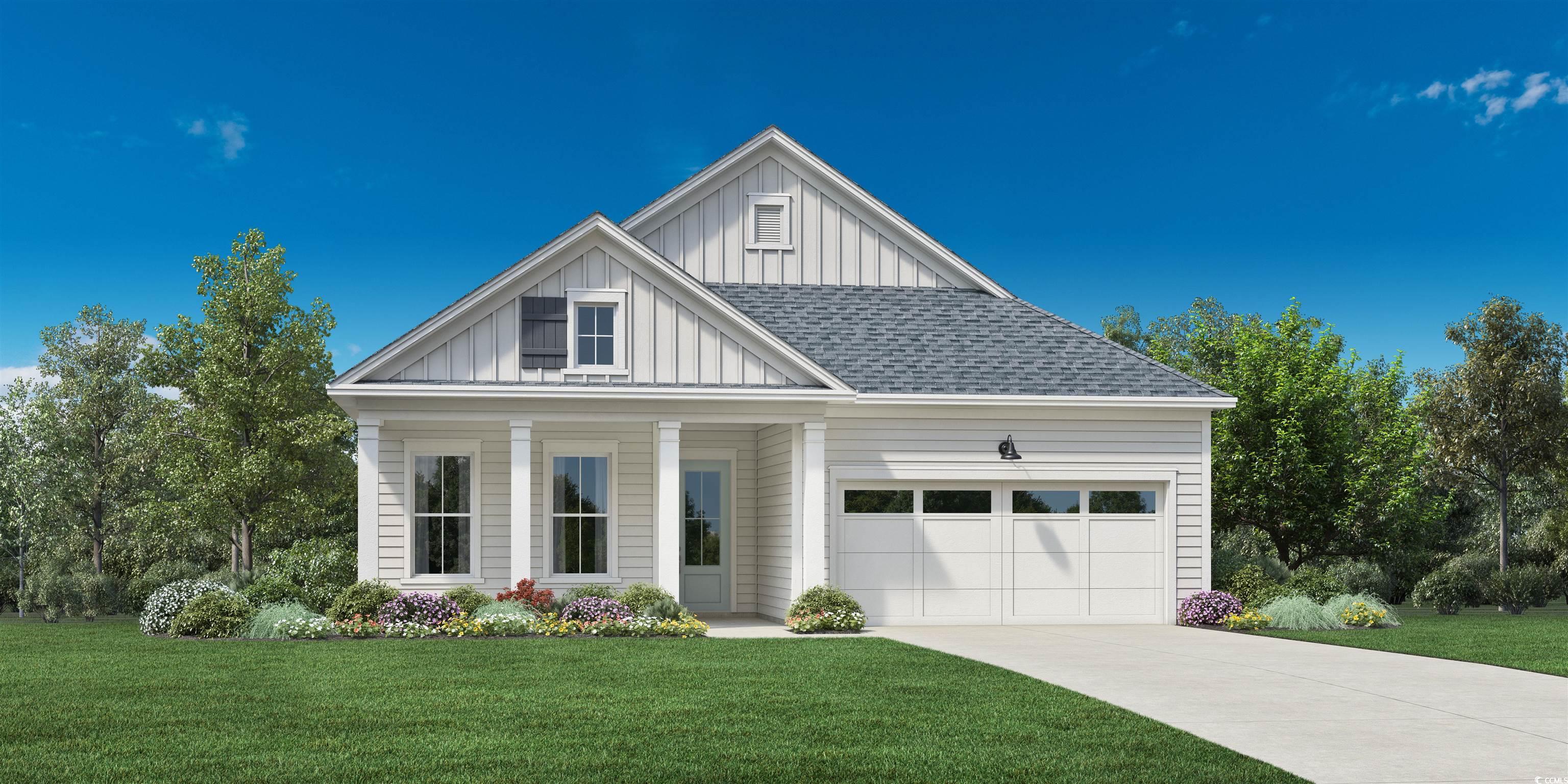 View of front facade with a garage and a front law