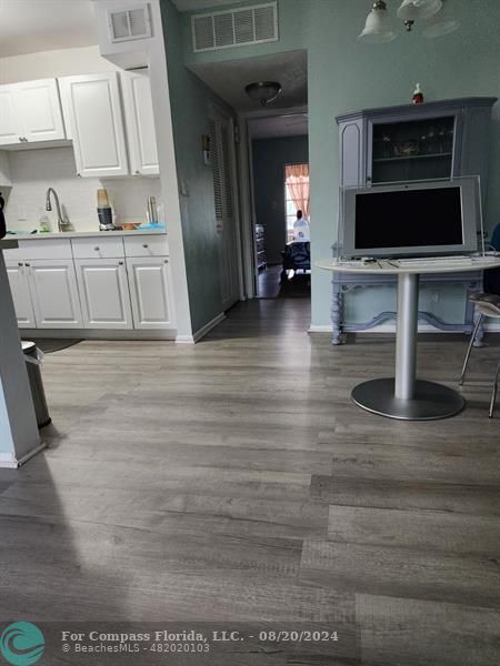 a kitchen with stainless steel appliances a stove microwave and sink