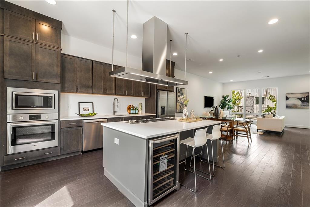 a kitchen with stainless steel appliances granite countertop a stove and a refrigerator