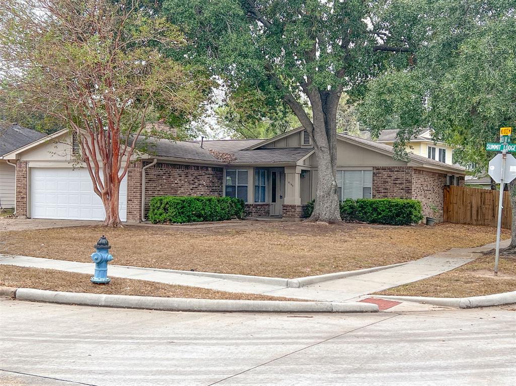 a view of a house with street that has a tree