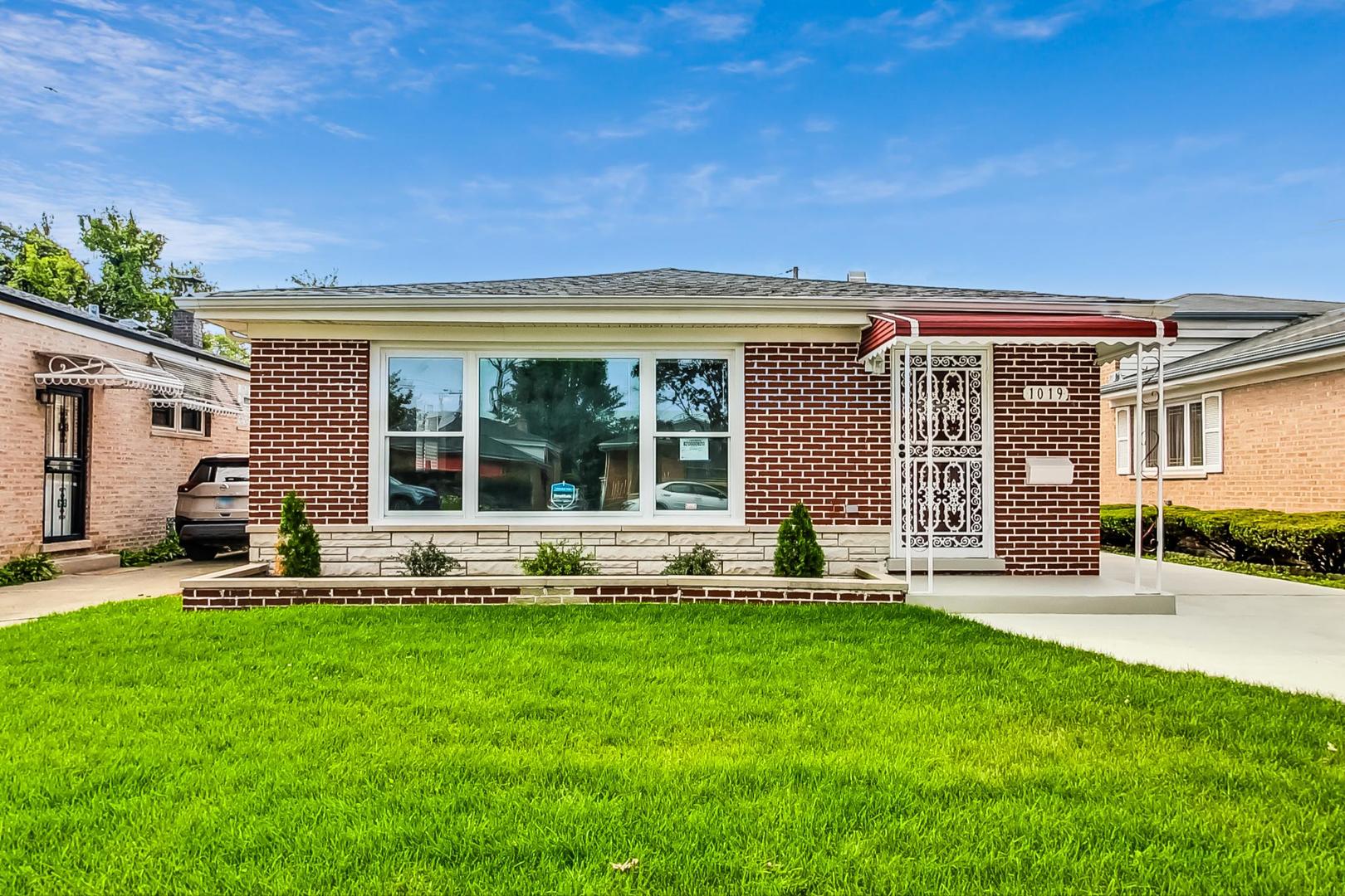 a front view of house with a garden and patio