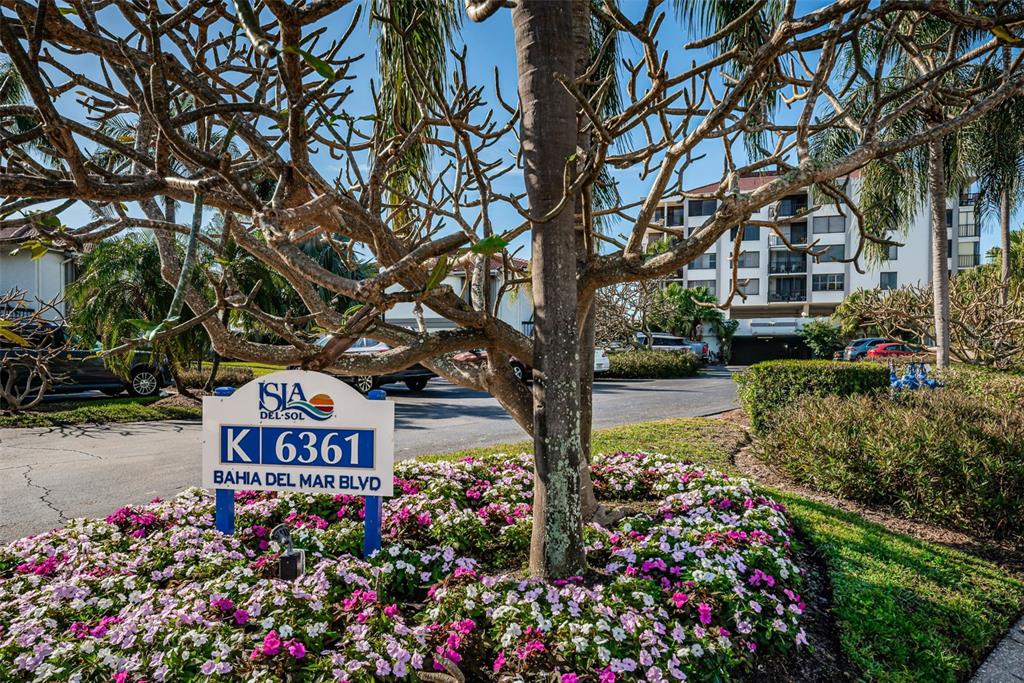 a view of sign board with flower around