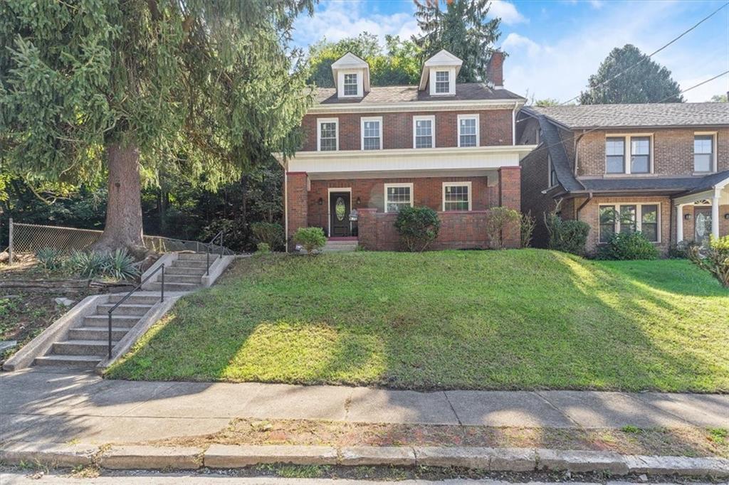 a front view of a house with a yard