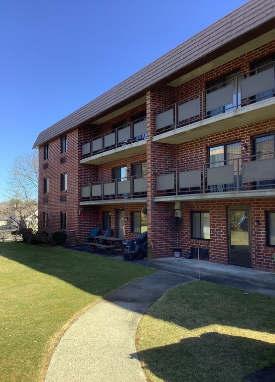 front view of a building with a yard