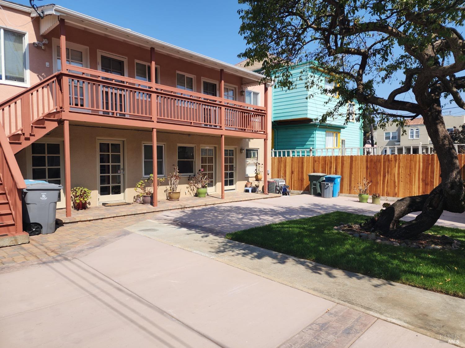 a front view of a house with a garden and tree