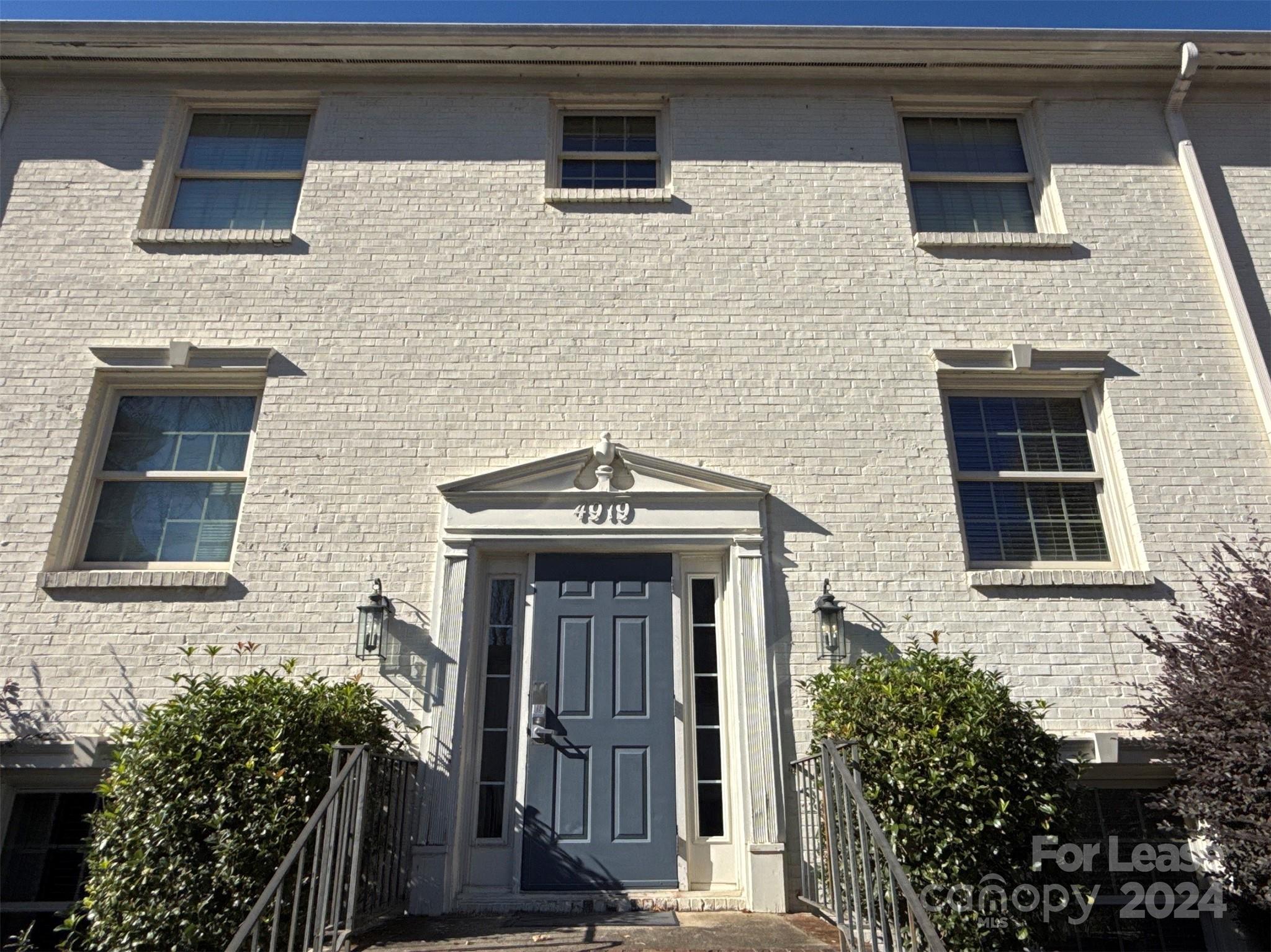 a front view of a house with stairs