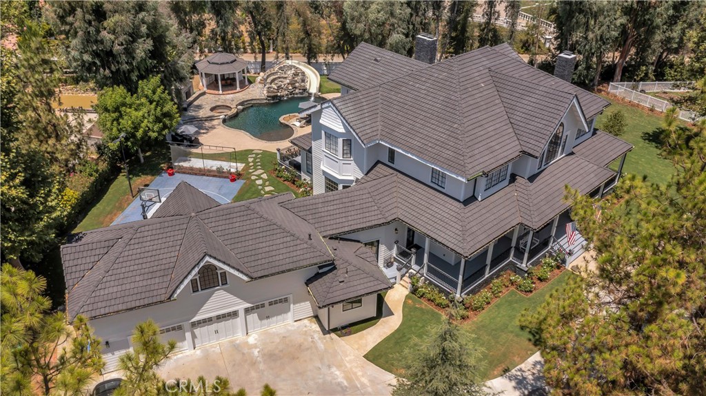 a aerial view of a house with a yard and balcony