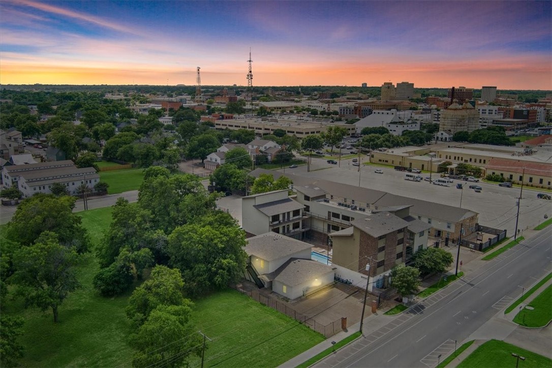 an aerial view of a house with a yard