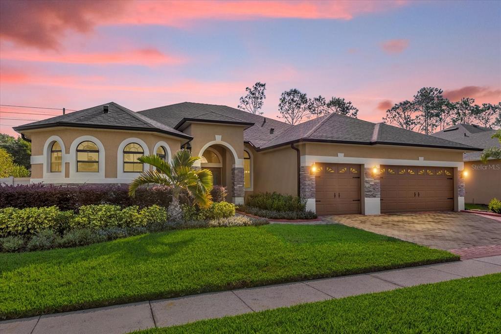 a front view of a house with a garden