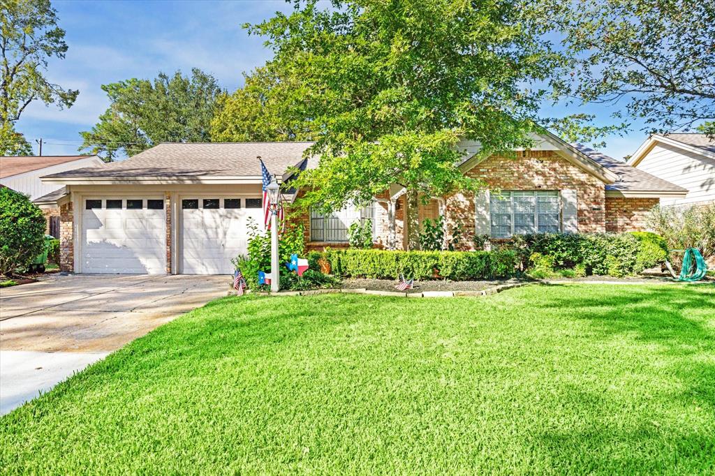 a view of a house with yard and a garden