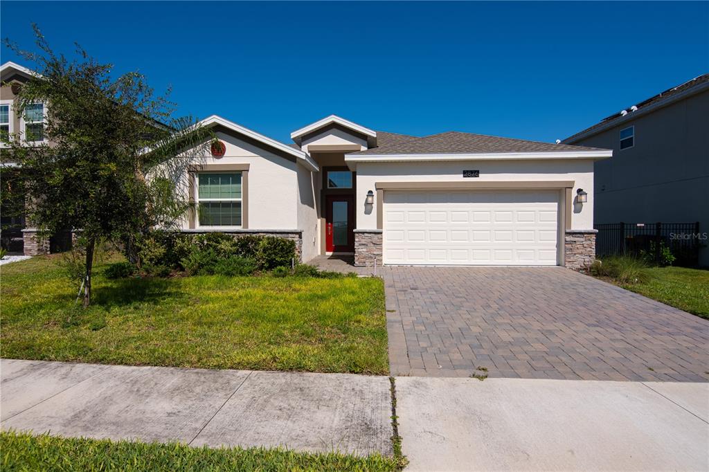 a front view of a house with a yard and garage