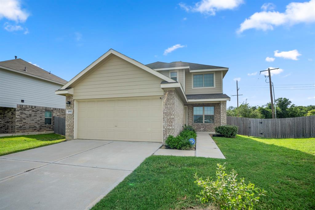 a front view of a house with a yard and garage