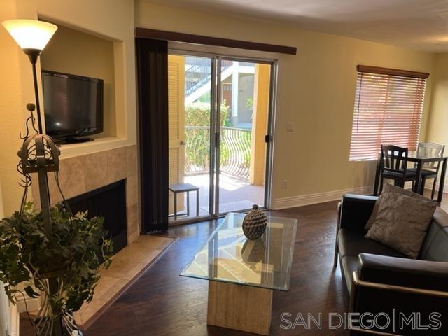 a living room with furniture a flat screen tv and a fireplace