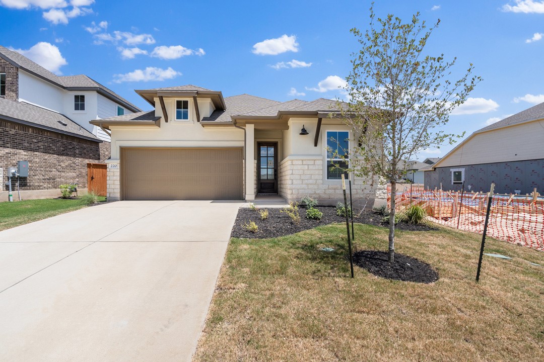 a view of a house with a patio and a yard