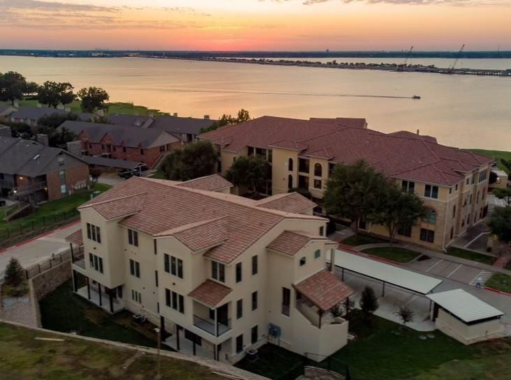 an aerial view of houses with a lake