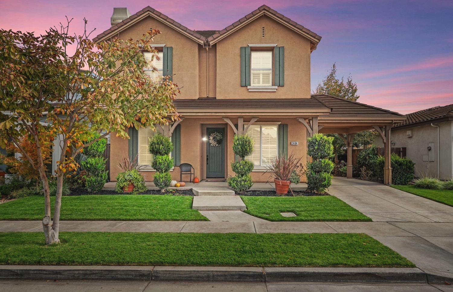 a front view of a house with garden