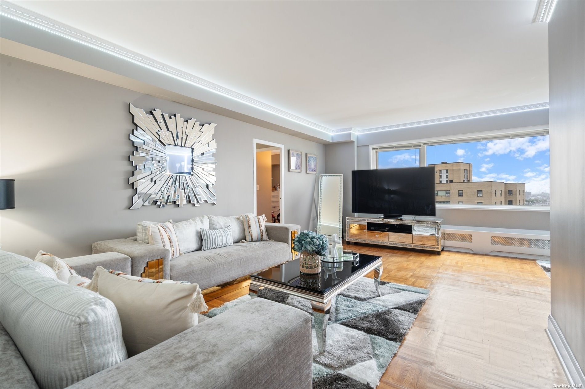 a living room with furniture and a flat screen tv