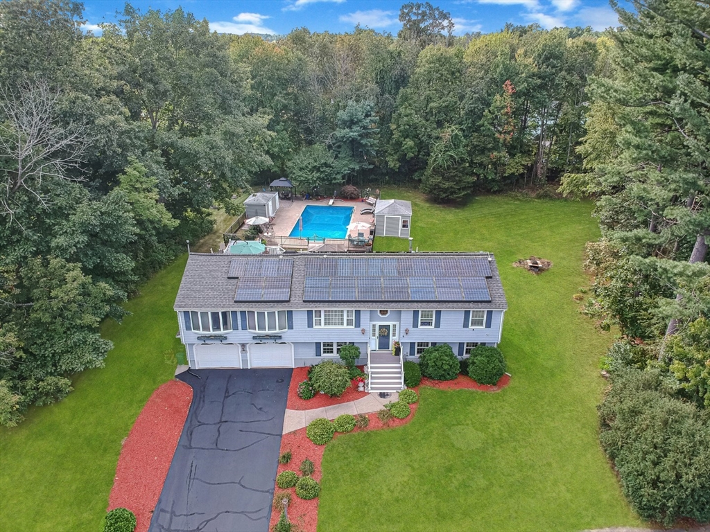 an aerial view of a house with big yard