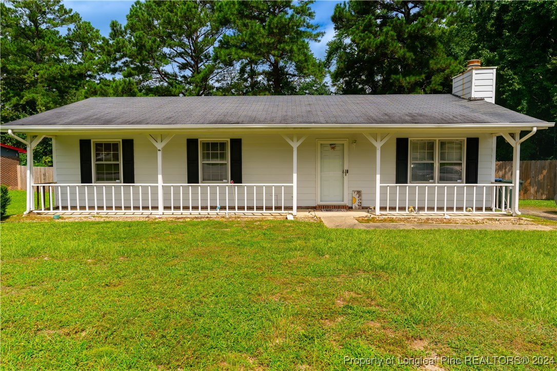 a front view of a house with a garden and yard