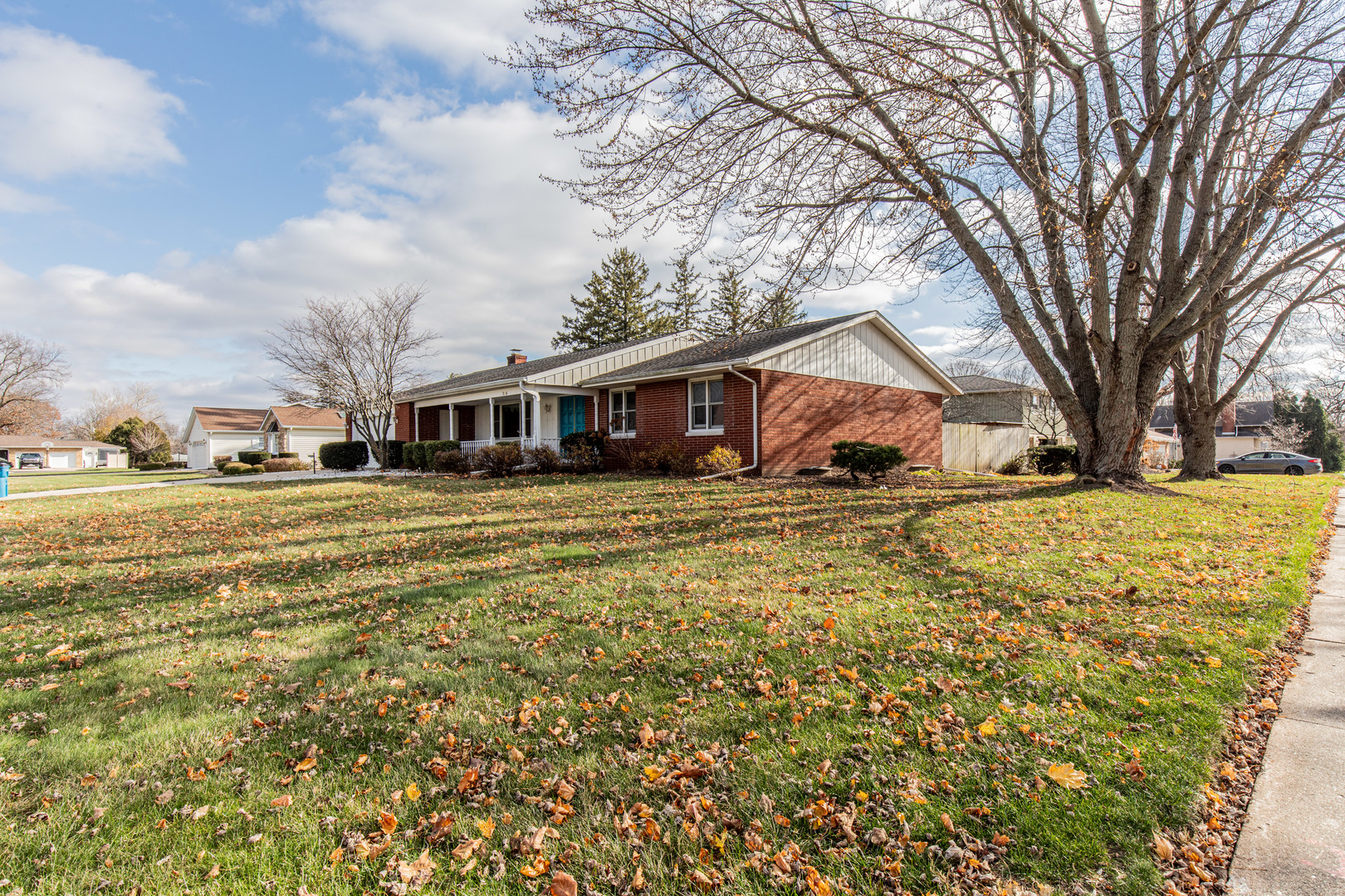 a view of a house with a yard covered with snow in front of house