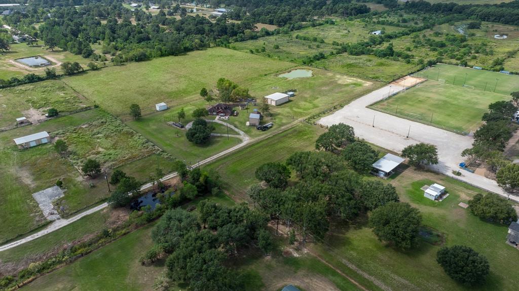 an aerial view of a houses with yard