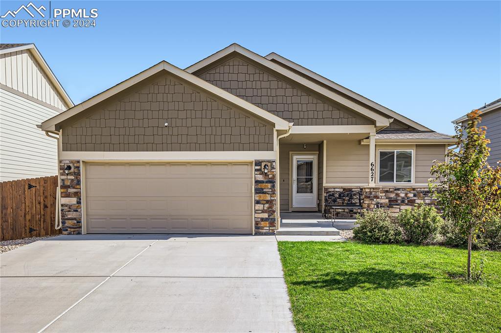 Craftsman-style home with a garage and a front yard