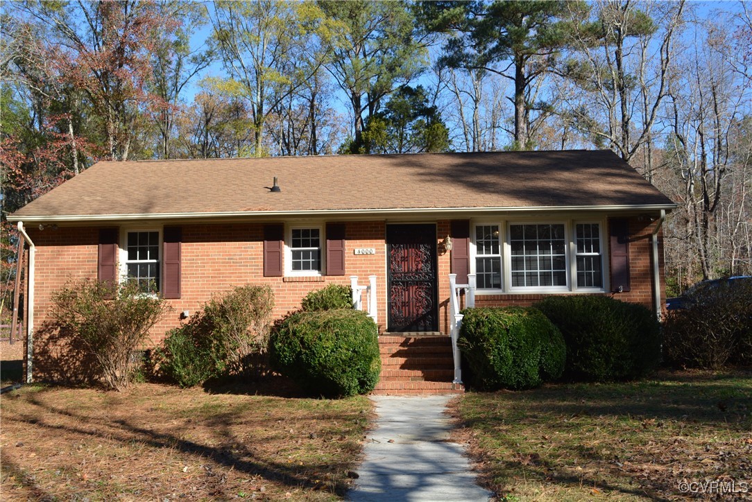 Single story home featuring a front lawn