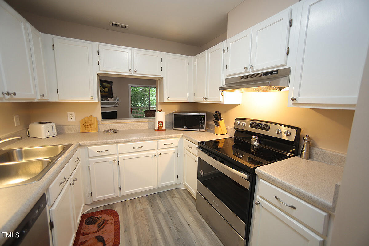 a kitchen with cabinets appliances and a sink