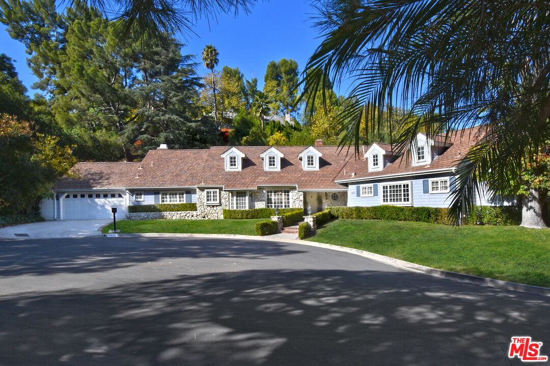 a view of a house with a yard and tree s