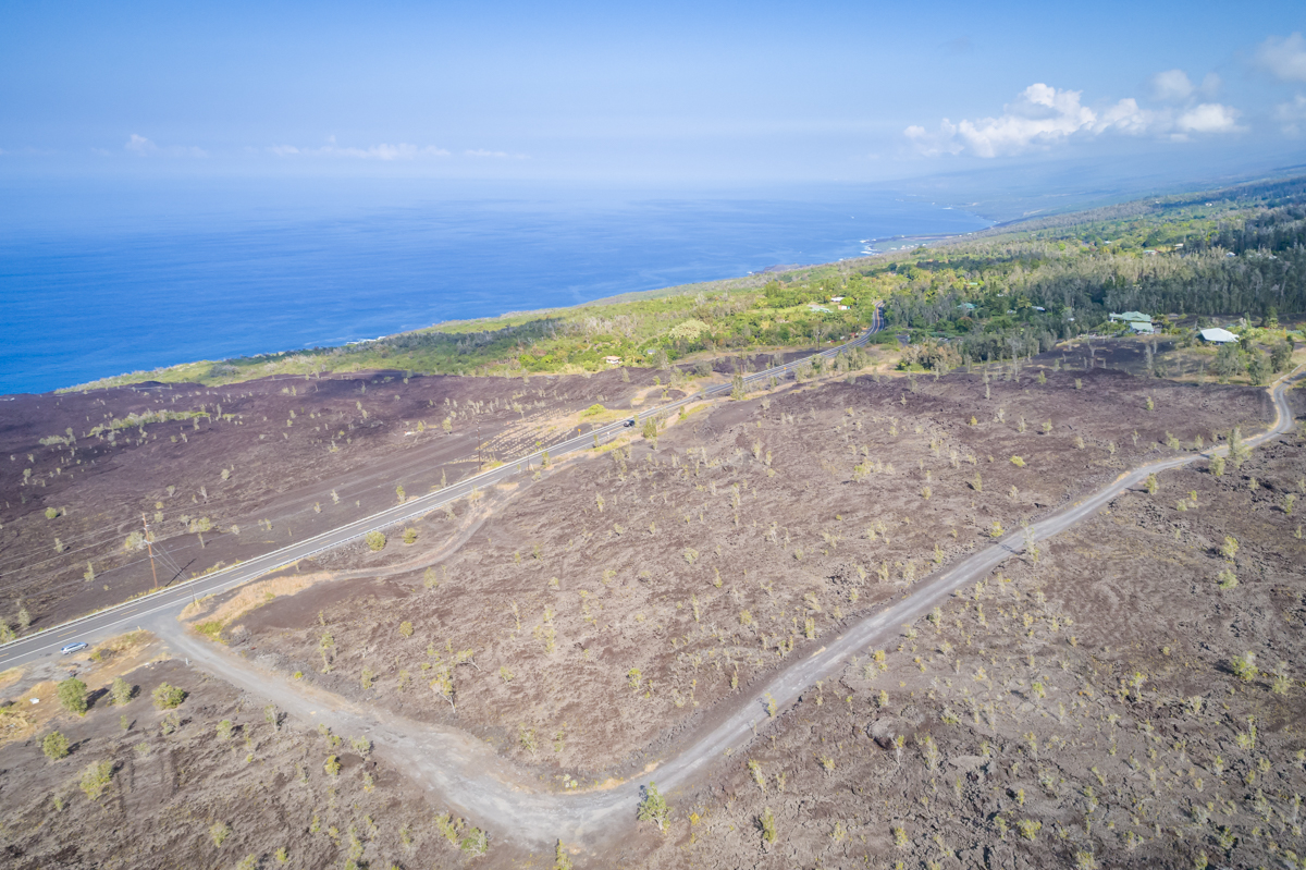 a view of a field with an ocean