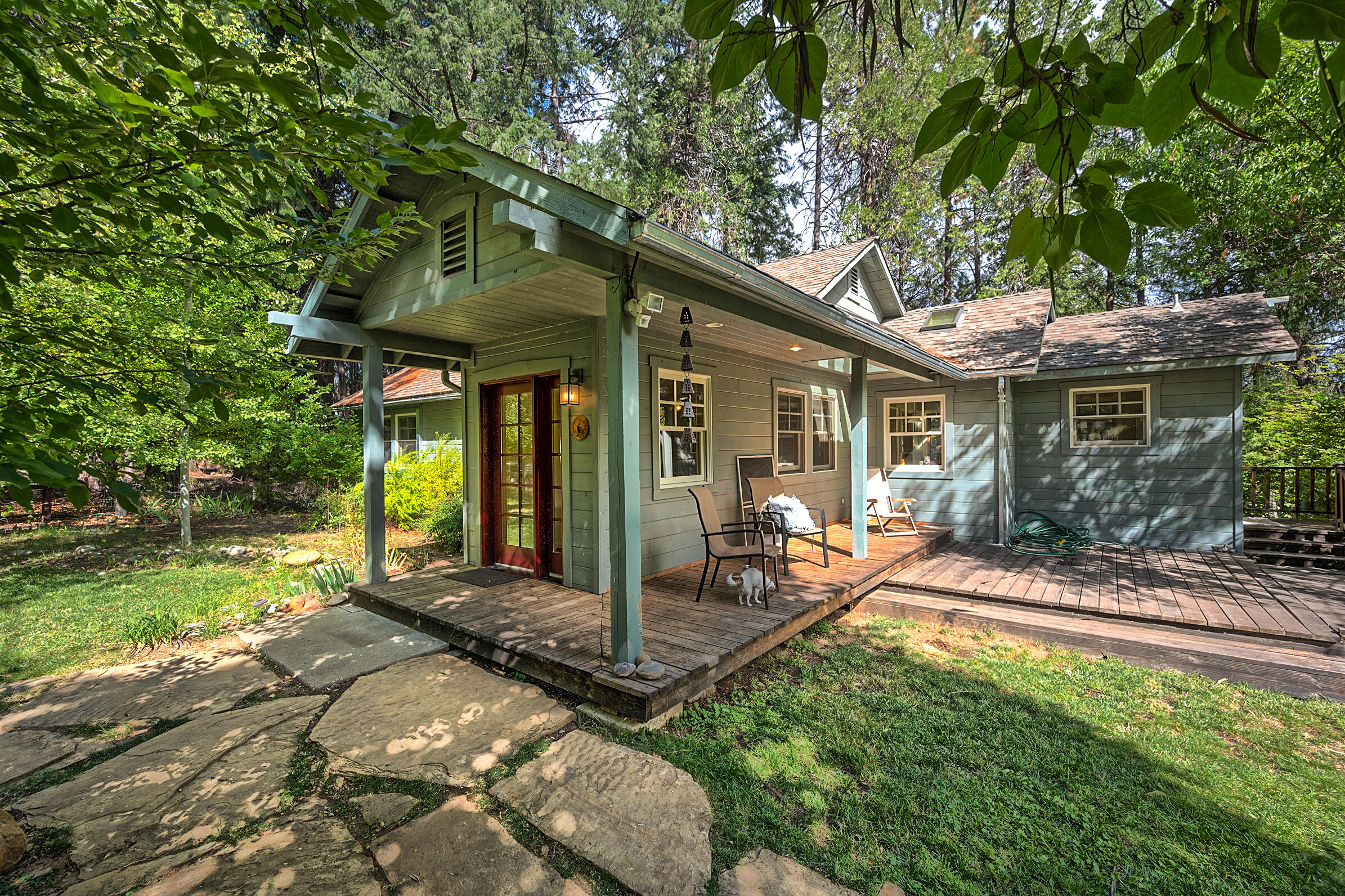 a view of a house with backyard porch and sitting area