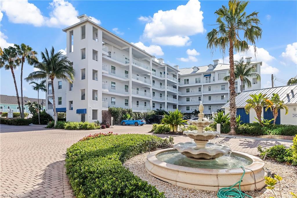 a building with palm trees and a yard