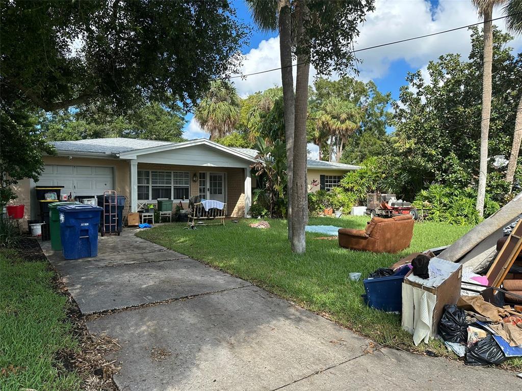 a view of a house with backyard porch and sitting area