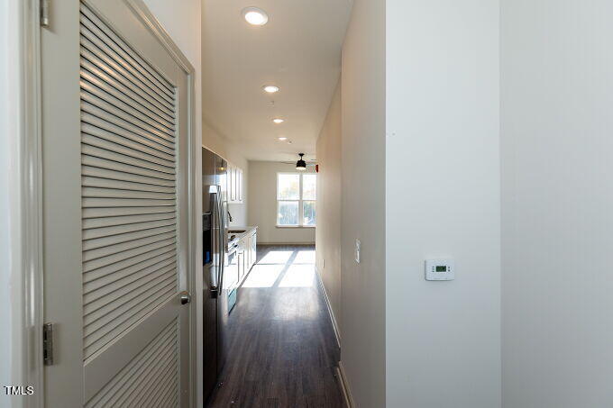 a view of a hallway with wooden floor