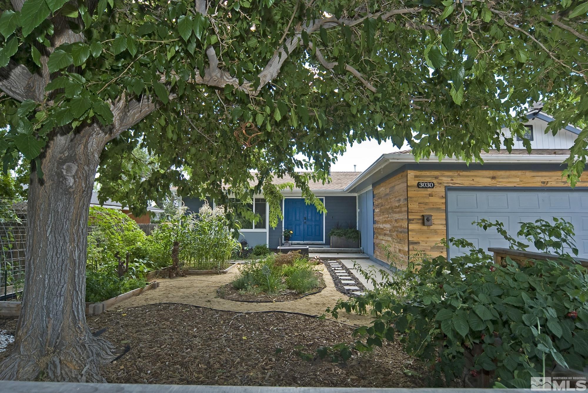 front view of a house with a tree