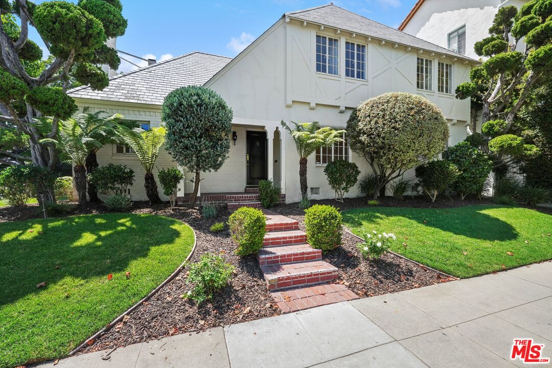 a front view of a house with garden