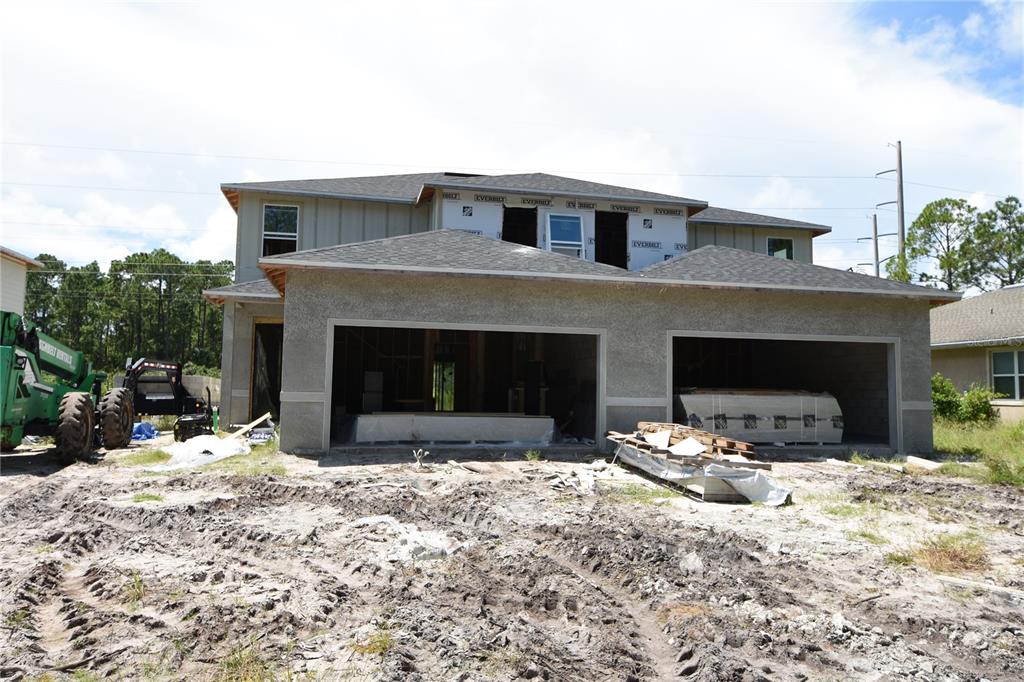 a front view of a house with two yard