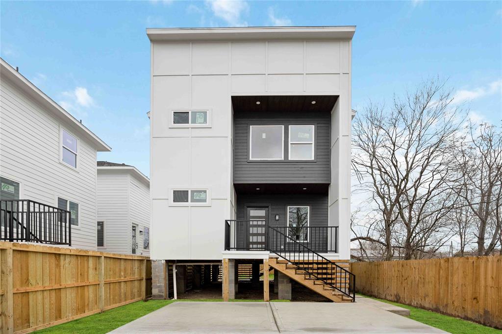 a view of a house with a yard and furniture