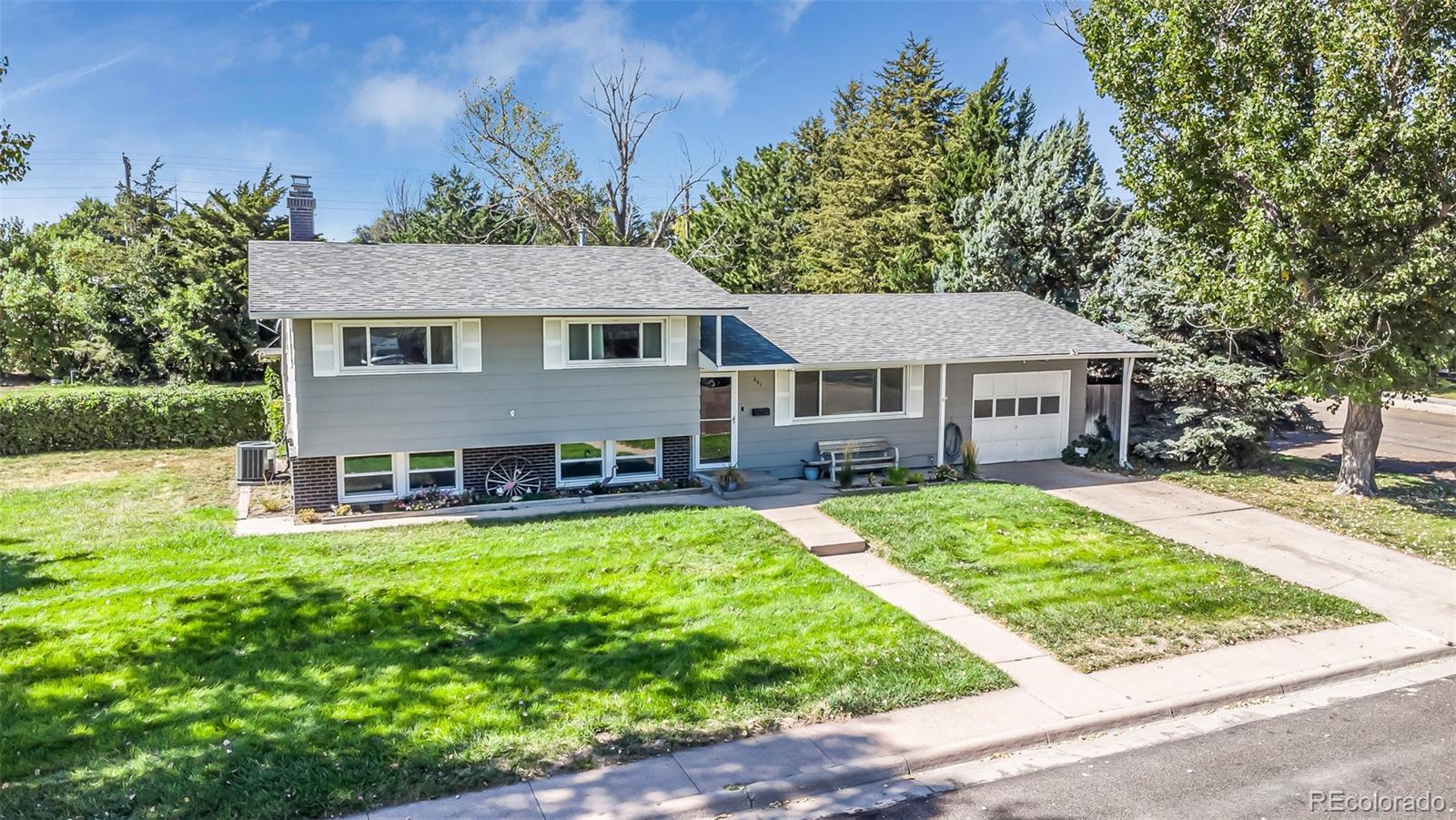 a view of a house with a yard patio and a small yard