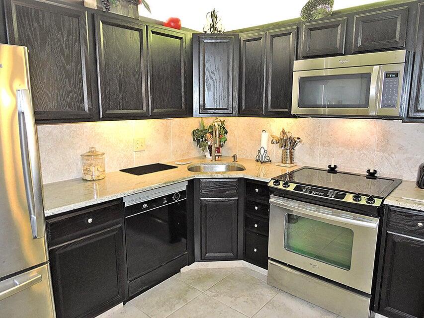 a kitchen with granite countertop a stove and a microwave