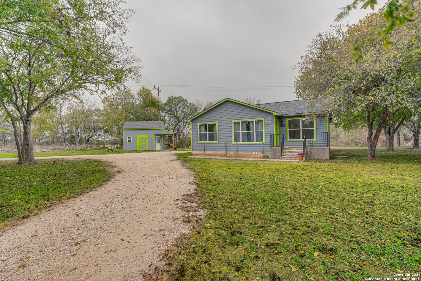 a front view of a house with yard and green space