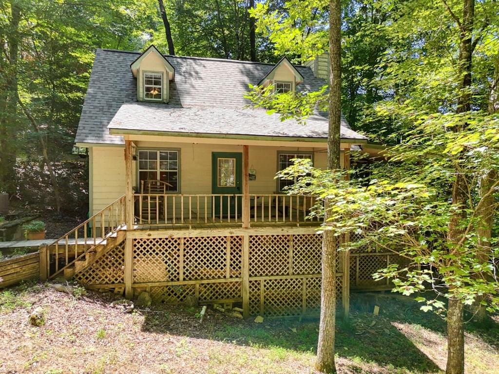 a view of a house with a small yard and wooden fence