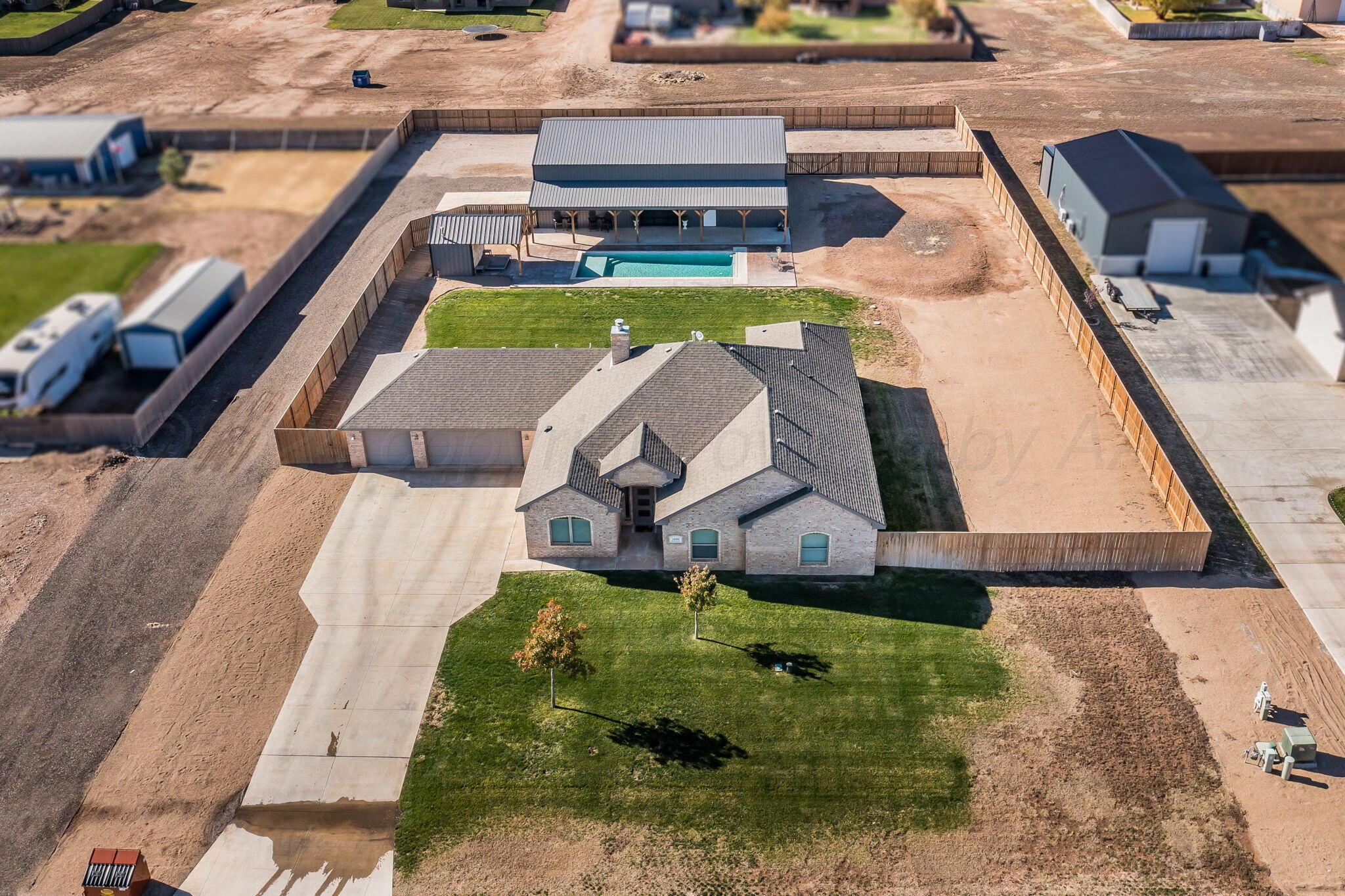 an aerial view of a house with swimming pool