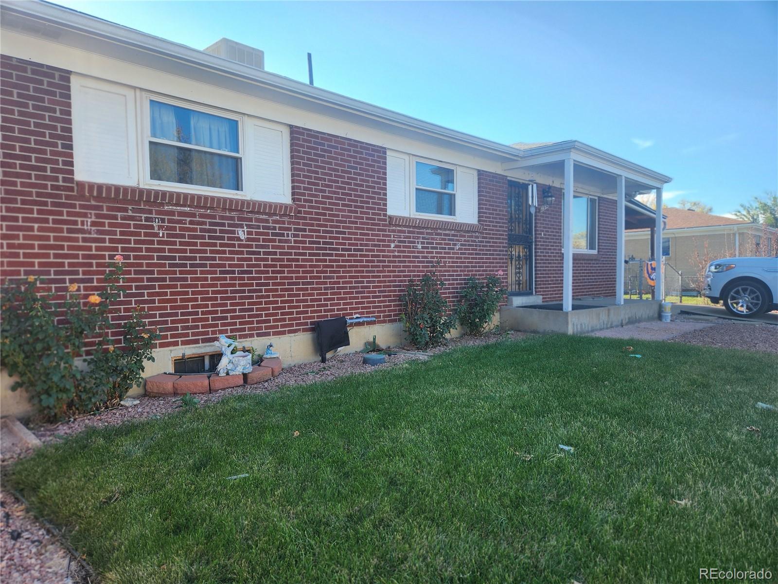 a front view of a house with a garden and yard