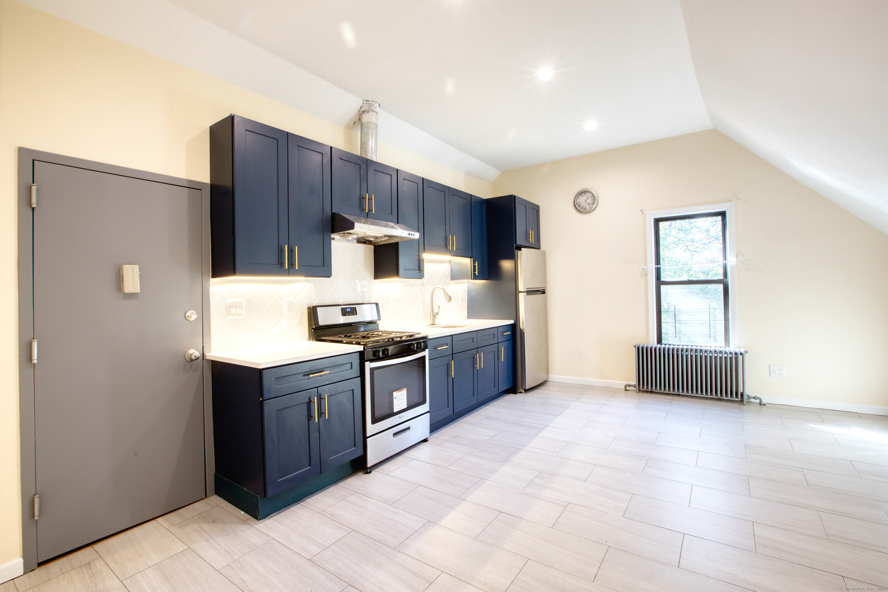 a kitchen with stainless steel appliances a refrigerator and a stove top oven