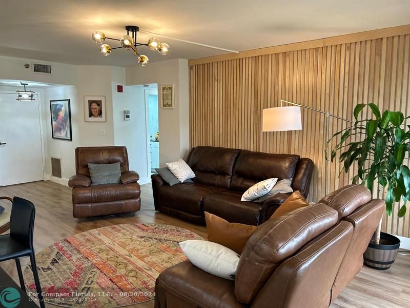 a living room with furniture and a lamp