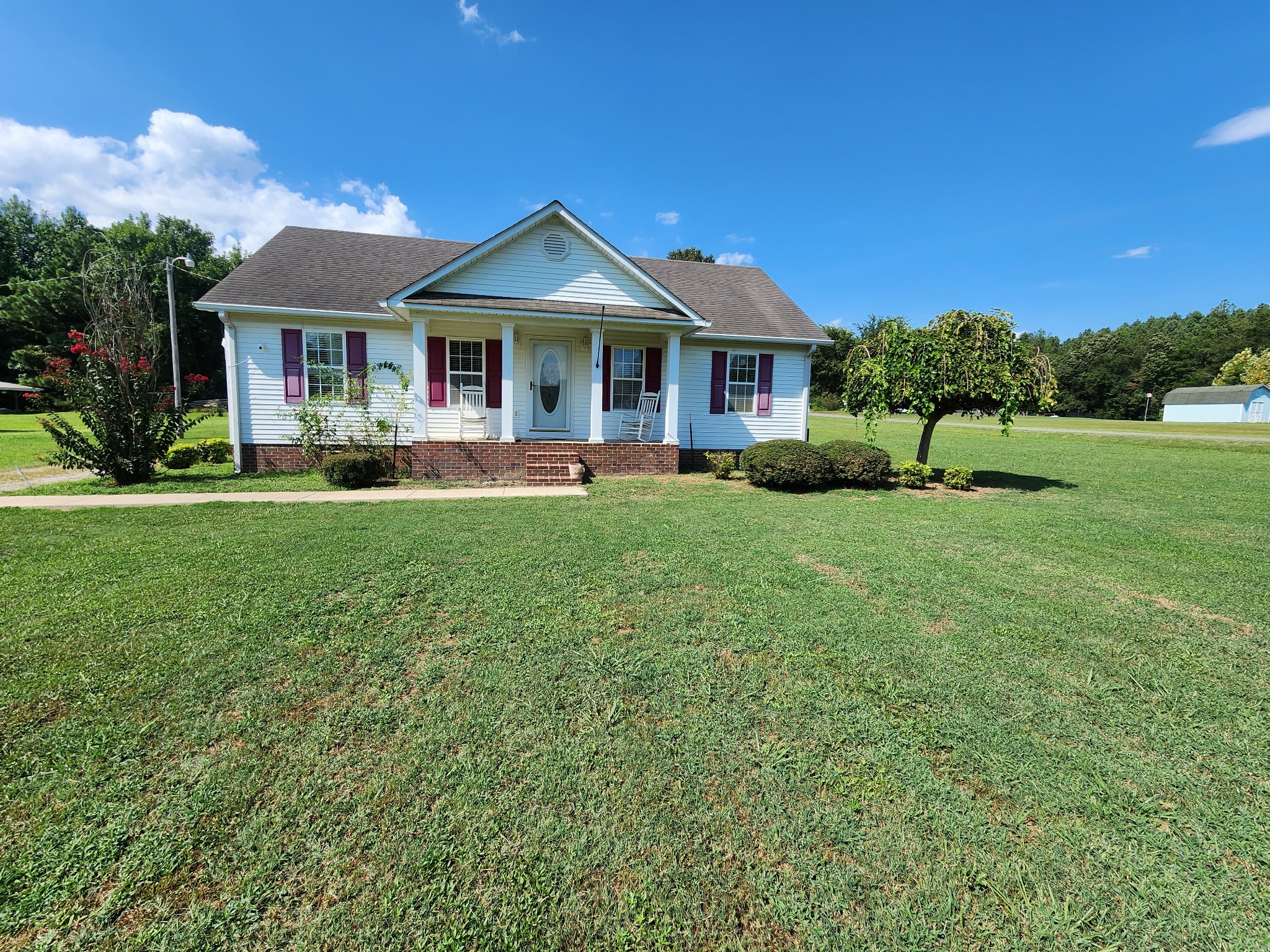 a front view of a house with a garden and porch