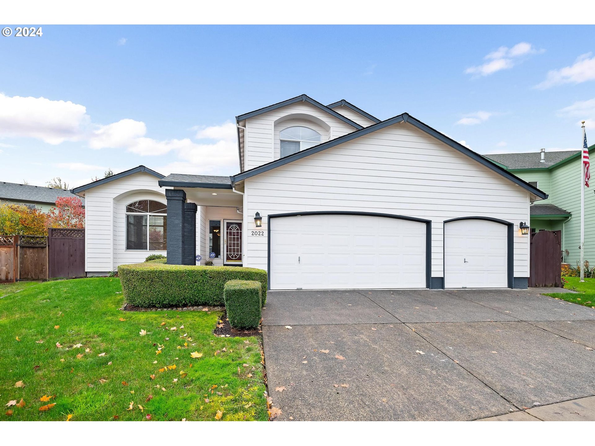 a view of a house with a yard and garage