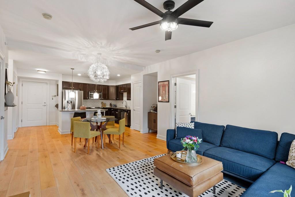 a living room with furniture and view of kitchen