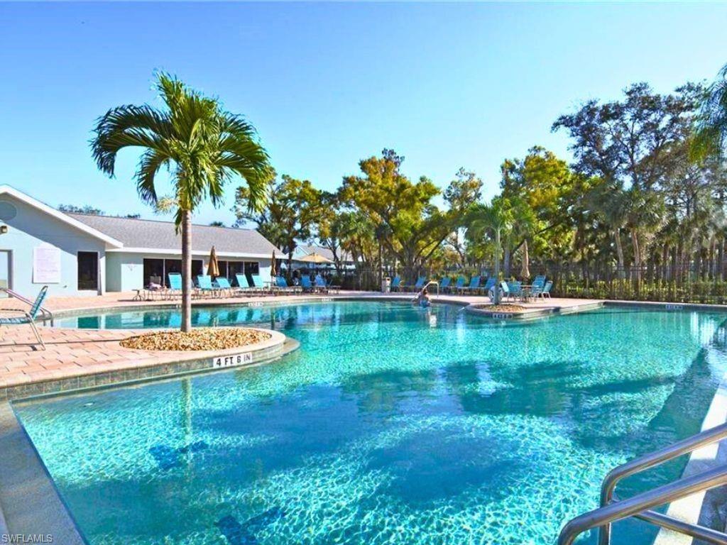 a swimming pool with outdoor seating and yard